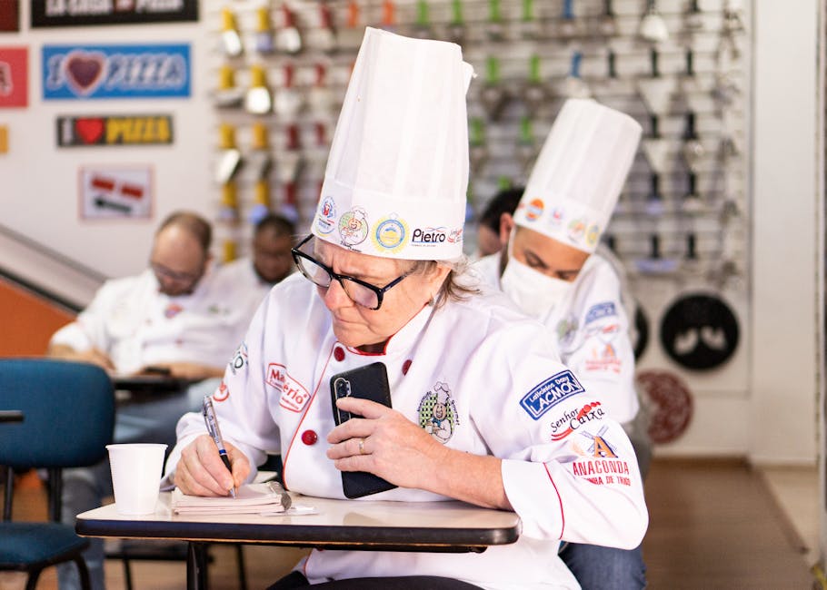 Chefs in a cooking class take notes and focus on learning new skills. Perfect for culinary themes.